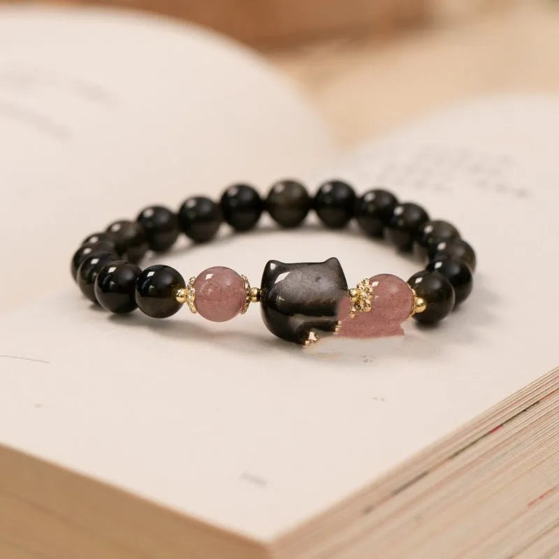 Black obsidian bead bracelet with cat charm on adjustable fastening