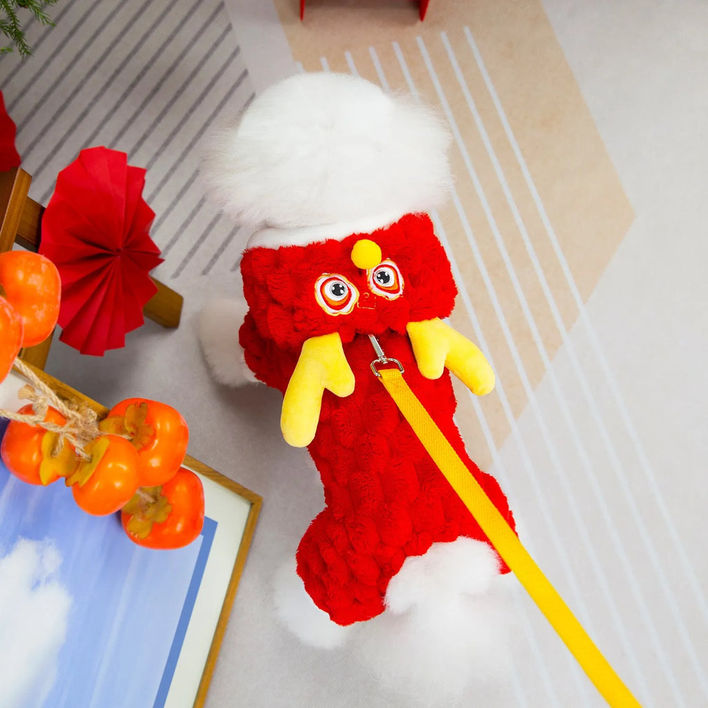 Red double-sided velvet pet jacket with cartoon dragon design shown on dog model