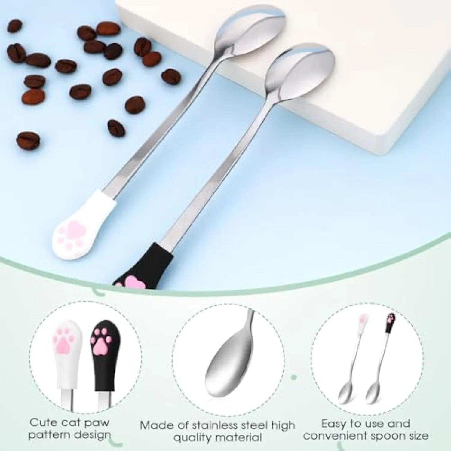 White and black stainless steel pet food spoons with cat paw print design and silicone handles.