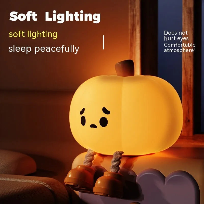 Soft orange silicone pumpkin-shaped night light with a warm glowing light.