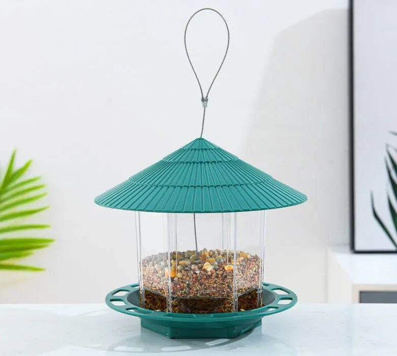 Outdoor garden hanging transparent bird feeder in green PP material with automatic feeding mechanism