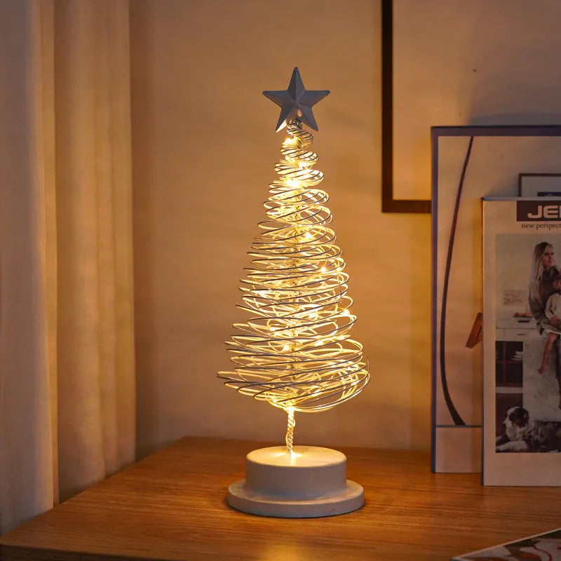 33cm wrought iron Christmas tree spiral light ornament with warm white LED illumination on table