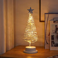 33cm wrought iron Christmas tree spiral light ornament with warm white LED illumination on table