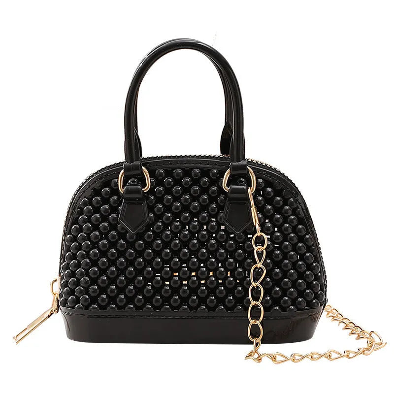 Translucent PVC jelly shell handbag with hollowed design and metal chain strap in apricot colour