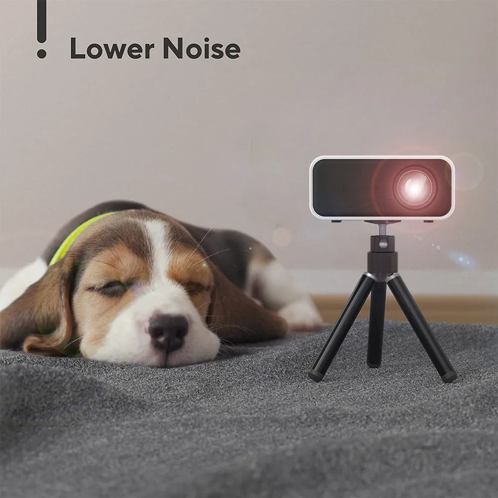 YT300 black portable mini projector with remote control on table showing projection