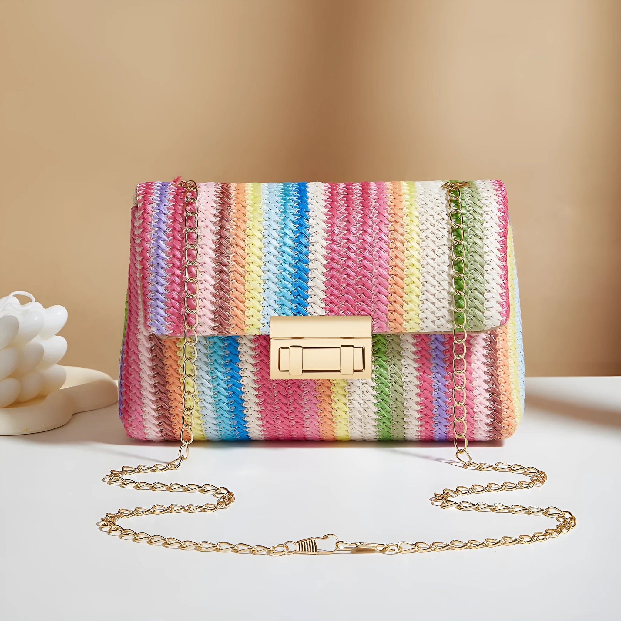 Women's straw cross-body bag with lock detail in rainbow colour showing square shape
