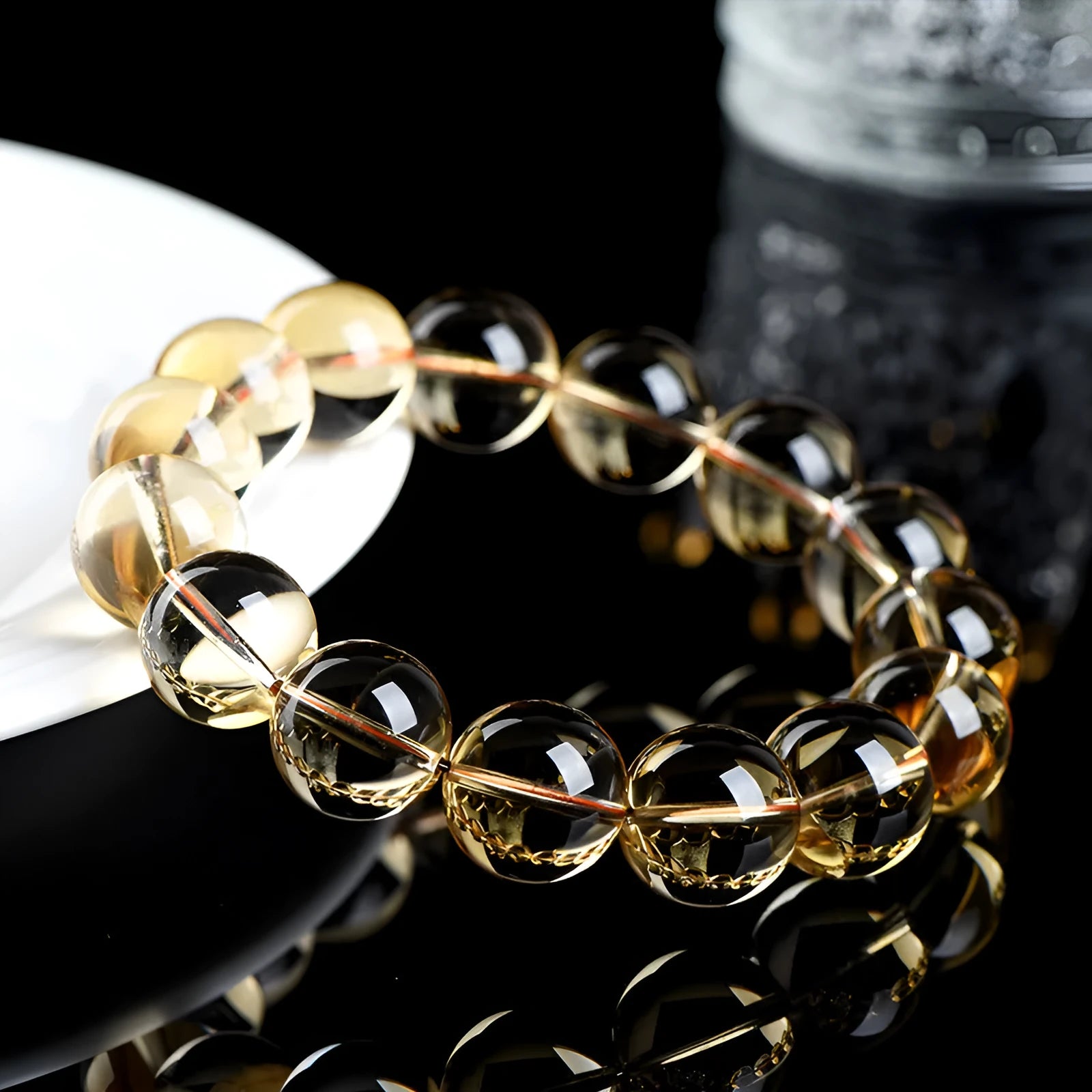 Original design bracelet with scattered, polished natural citrine beads in golden yellow tones on a wrist.