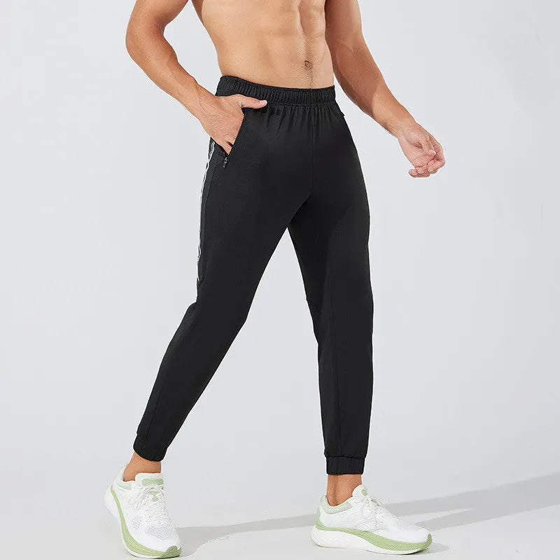 Men's black polyester running trousers with mid waist, shown flat.