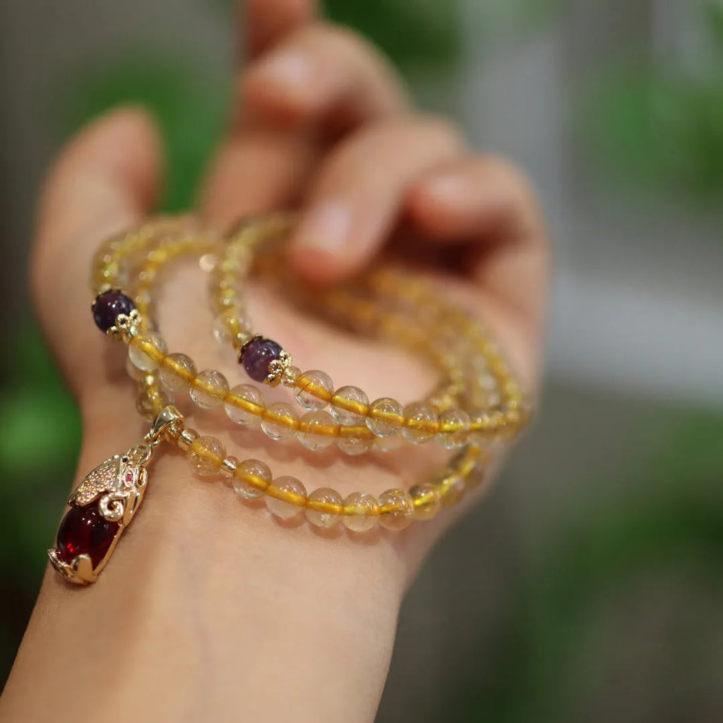 Brazilian rutilated quartz bracelet with Chinese style three-ring gold design in natural gold colour