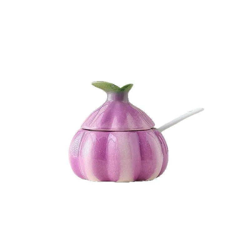 Ceramic onion seasoning jar with cover and spoon in modern simplicity style on a kitchen countertop