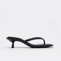 Women's khaki round toe flip-flop sandals with a mid heel on a plain background.