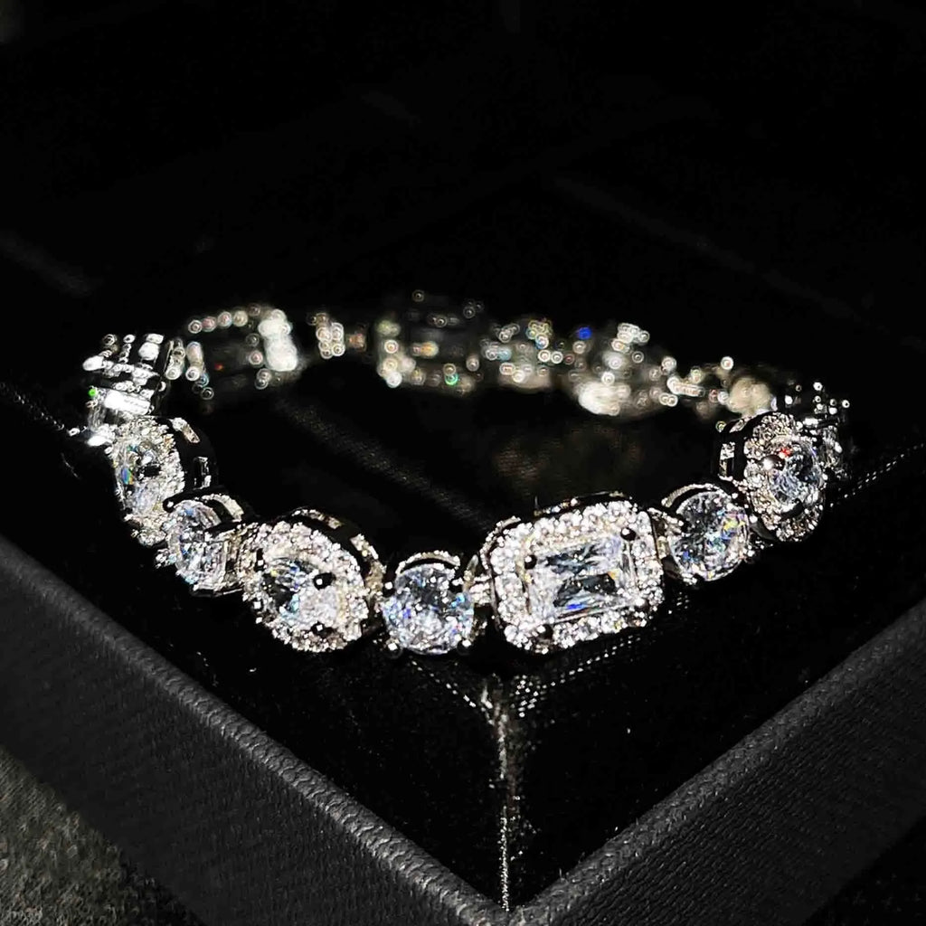 Women's geometric silver bracelet with adjustable chain and sparkling zircon stone on a wrist.
