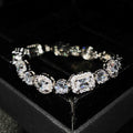 Women's geometric silver bracelet with adjustable chain and sparkling zircon stone on a wrist.