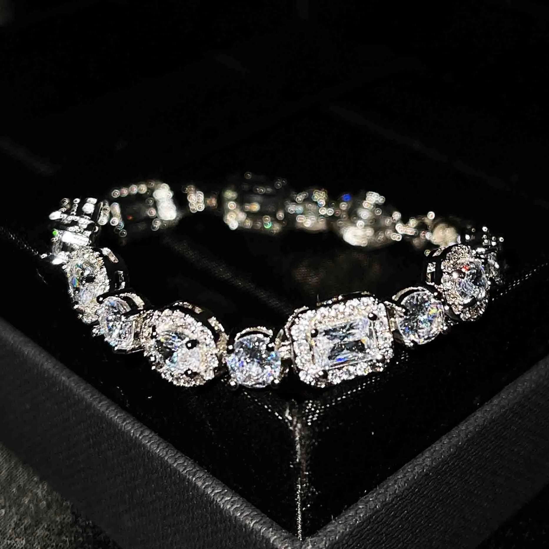 Women's geometric silver bracelet with adjustable chain and sparkling zircon stone on a wrist.