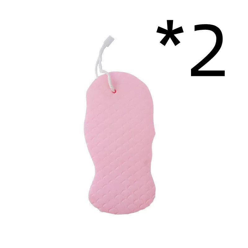 White 3D fish scale pattern bath sponge with hang loop on a bathroom background.