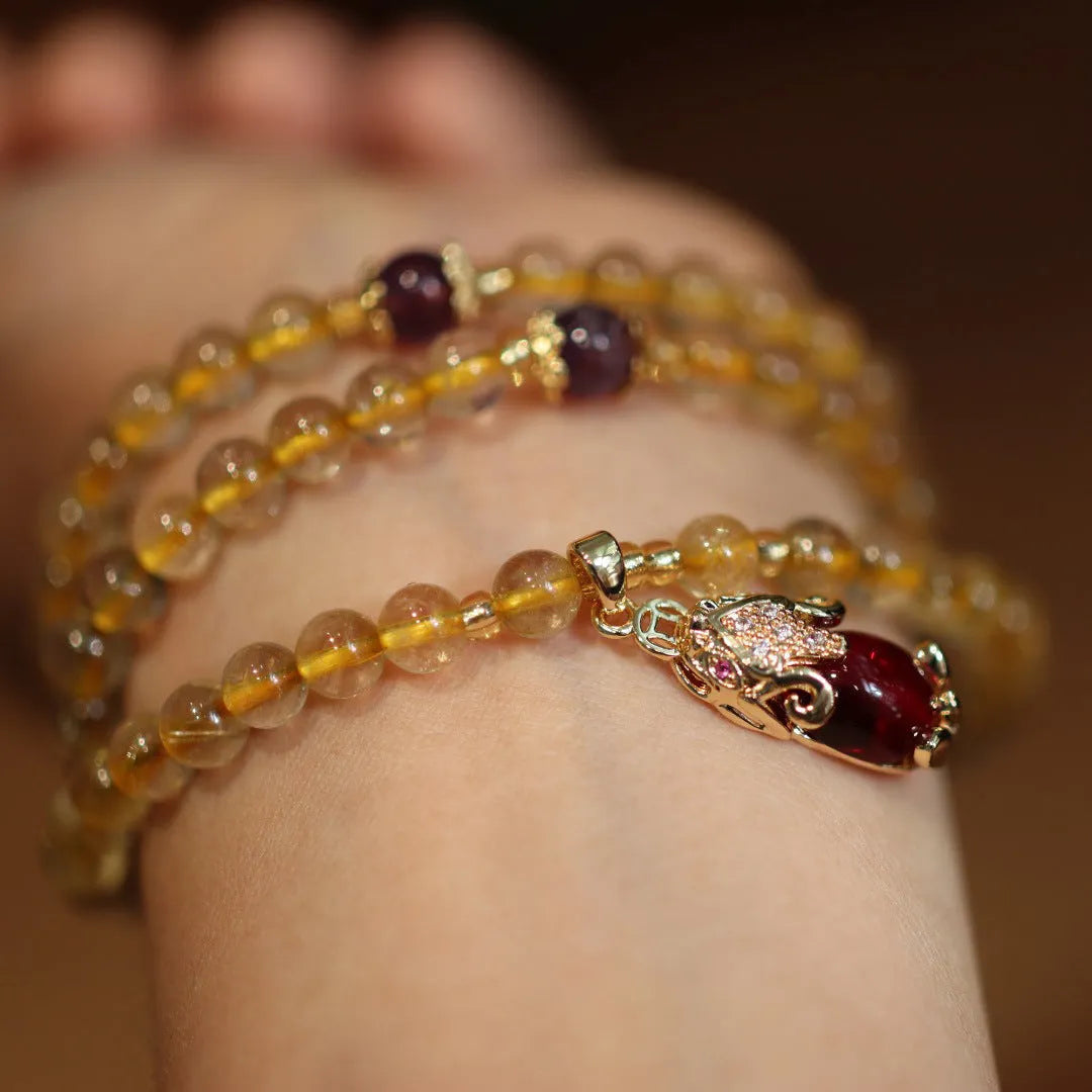 Brazilian rutilated quartz bracelet with Chinese style three-ring gold design in natural gold colour
