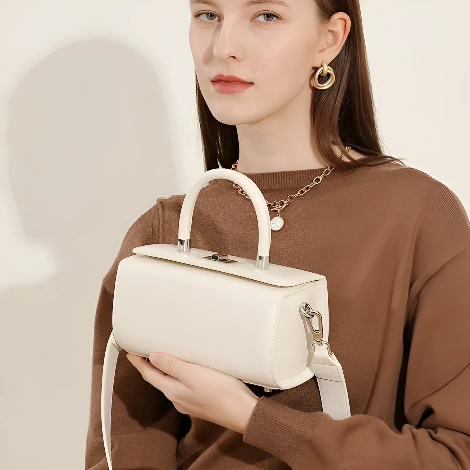 Women's leather crossbody bag in clamshell design with internal phone and document organisers