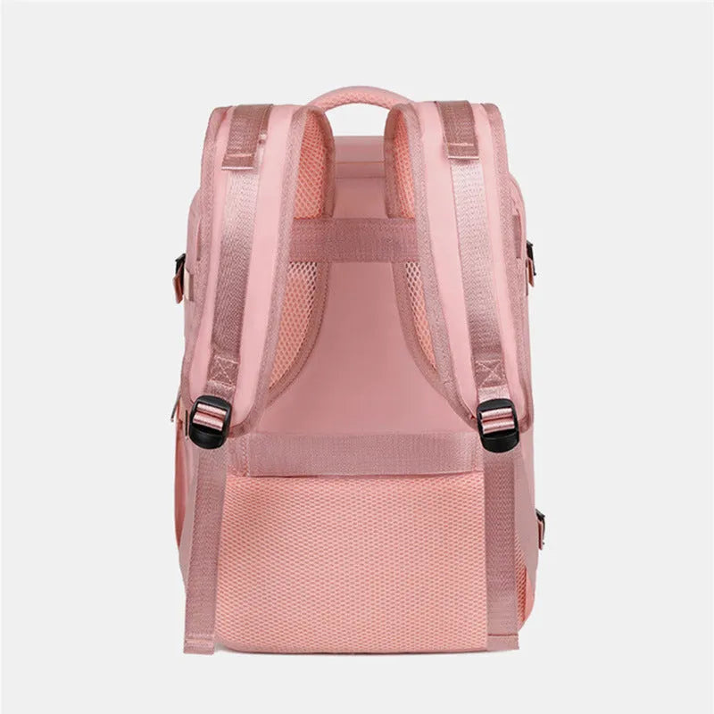 Large grey travel backpack with multiple compartments and an air pillow strap, shown next to a laptop.
