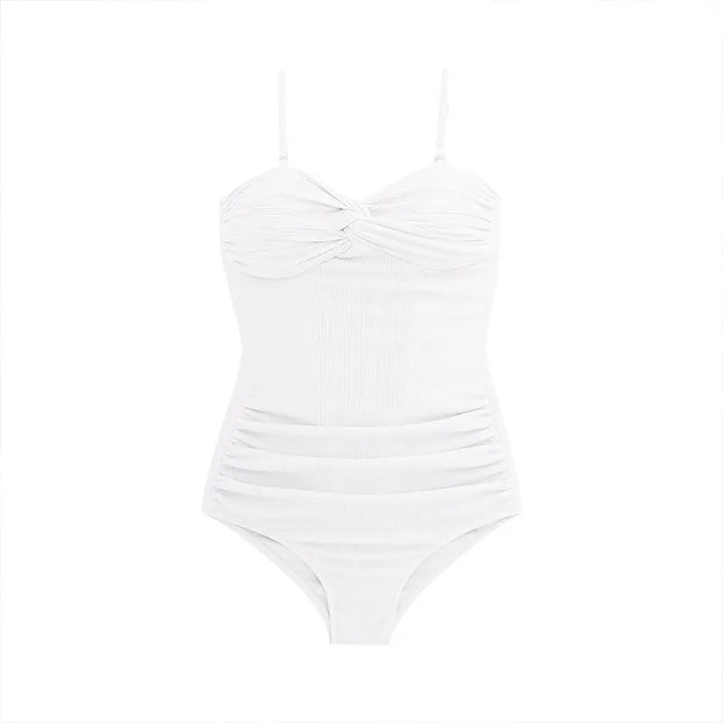 A woman modelling a solid colour one-piece swimsuit with adjustable suspender-style shoulder straps.