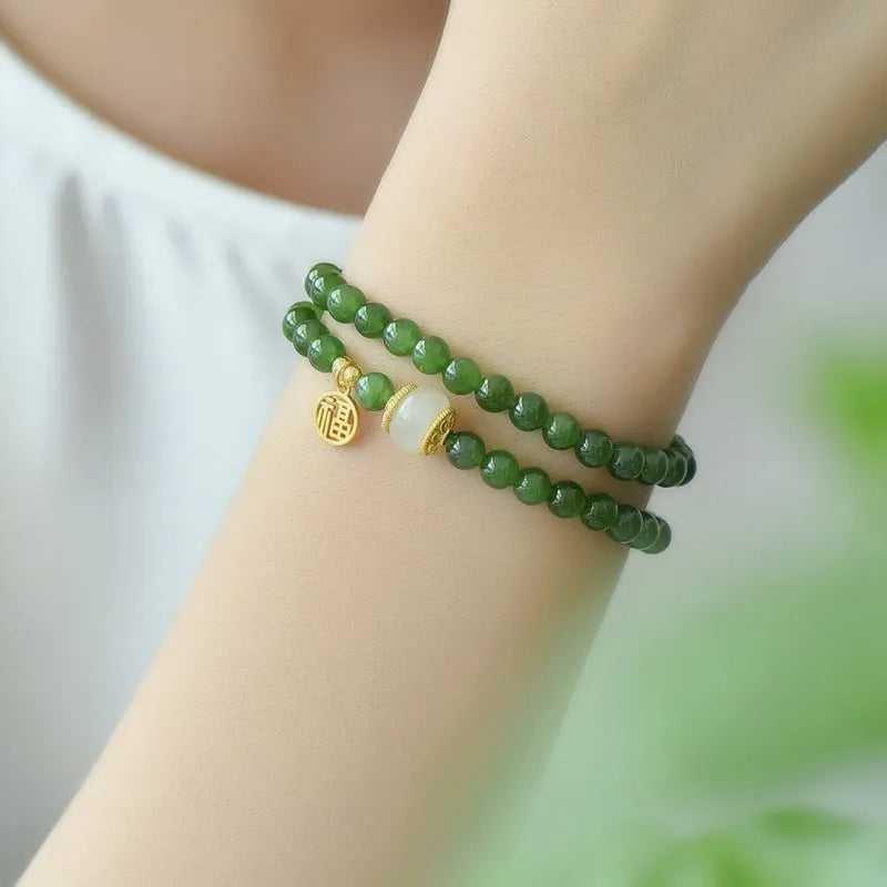 Natural Hetian jade double circle bracelet with 6mm beads and a carved fu character charm.