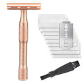 Old style manual double-sided alloy safety razor with replacement blades and cleaning brush on a table.