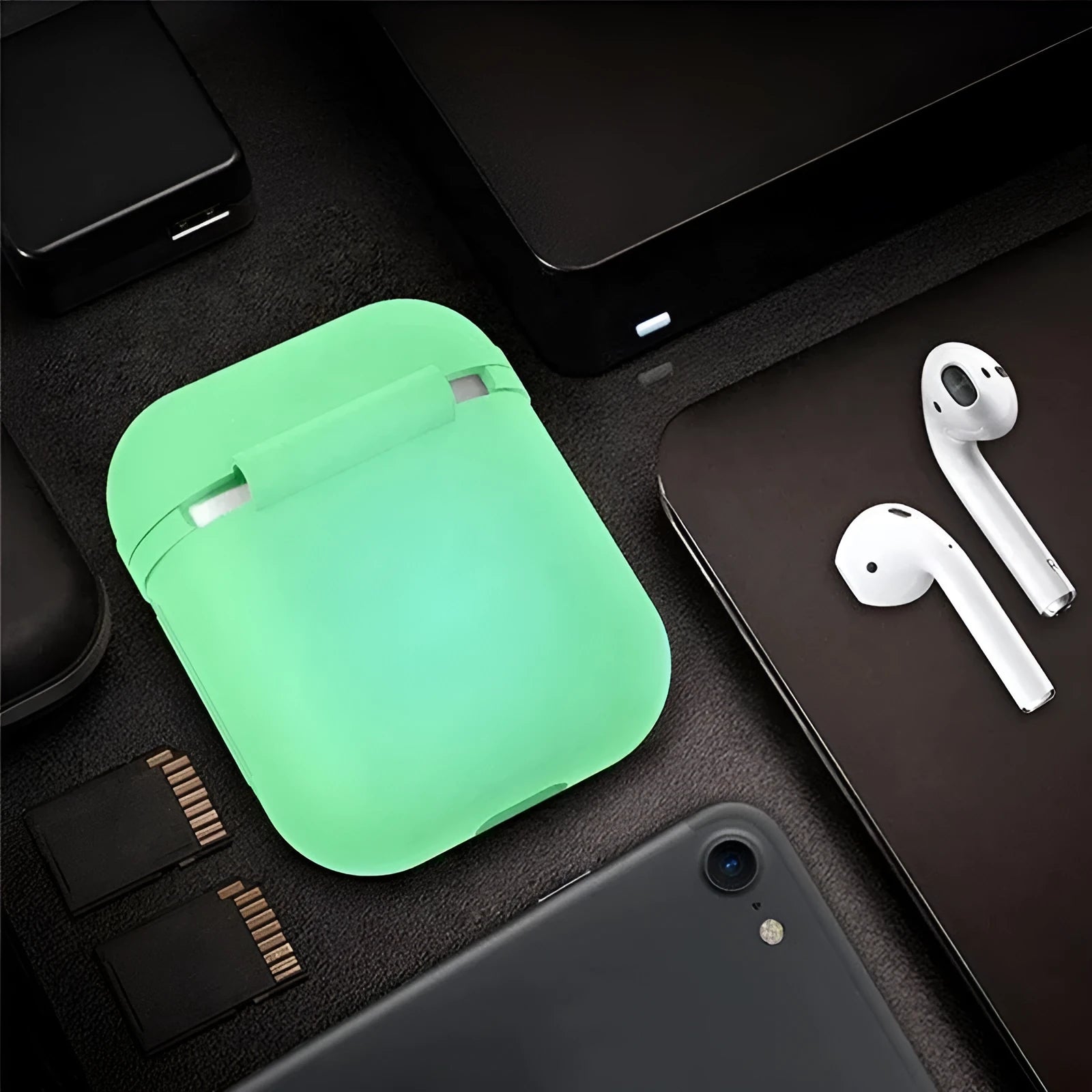 Glow-in-the-dark silicone flip-top protective case for Apple AirPods on a dark background