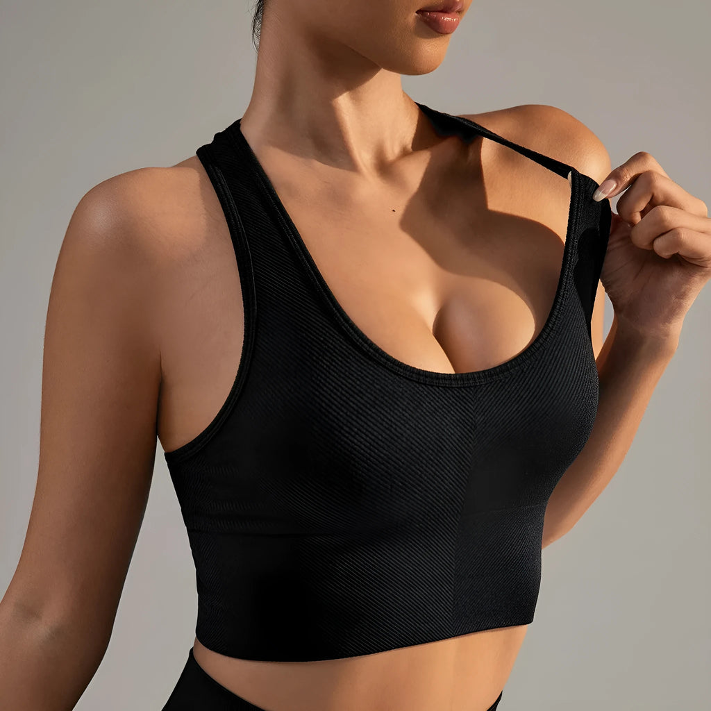 Black women's cross-back sports bra with moulded cups on a hanger