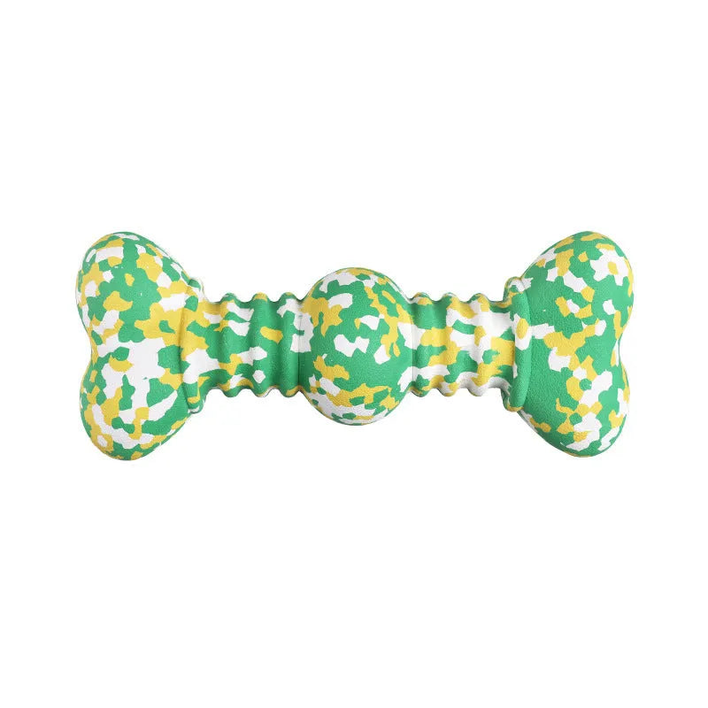 Green, white, and yellow camouflage pattern natural rubber bone chew toy for dogs on a wooden floor.