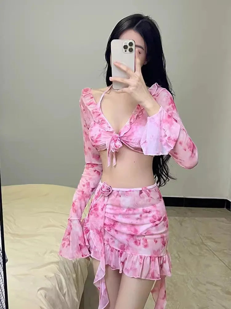 Women's cherry blossom pink floral print bikini swimsuit set laid flat.