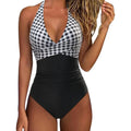 Female model wearing a printed lace-up backless bikini swimsuit in a floral pattern.