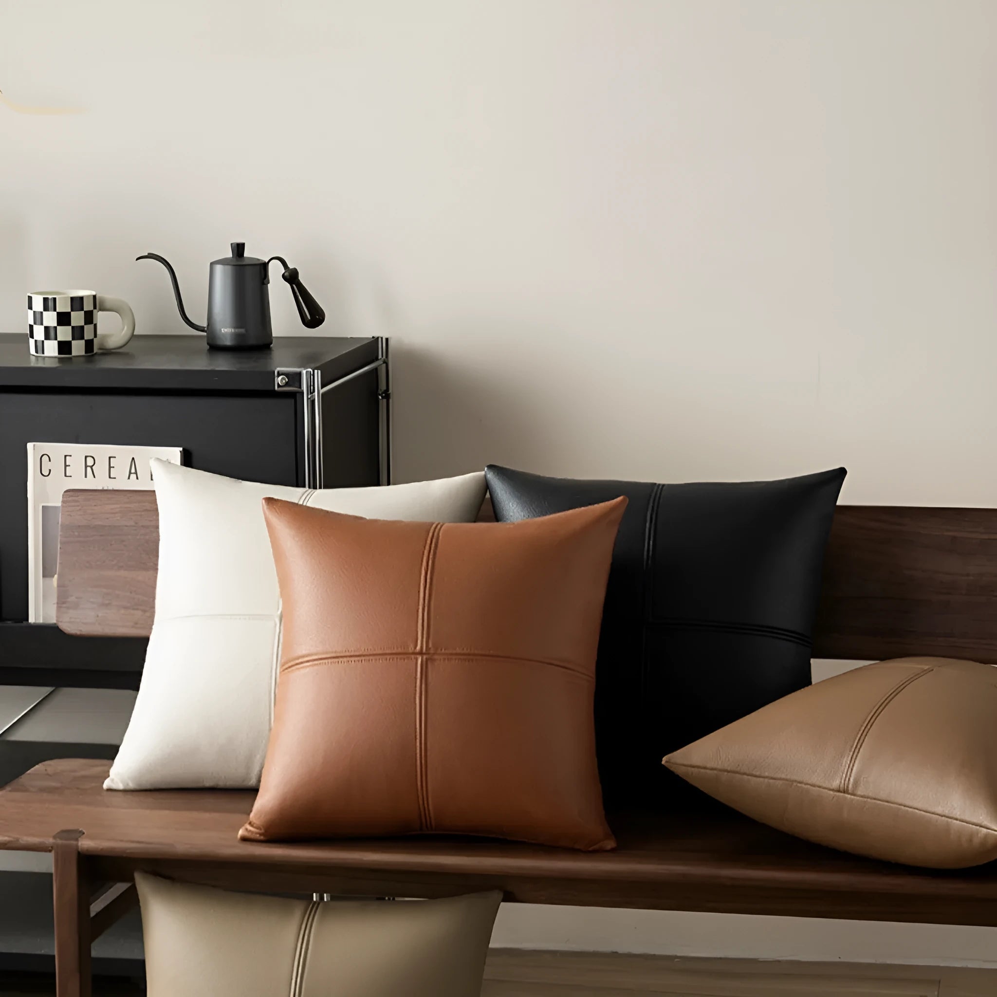 Soft cowhide leather pillow cover in a solid colour, shown in a Nordic-style interior setting.