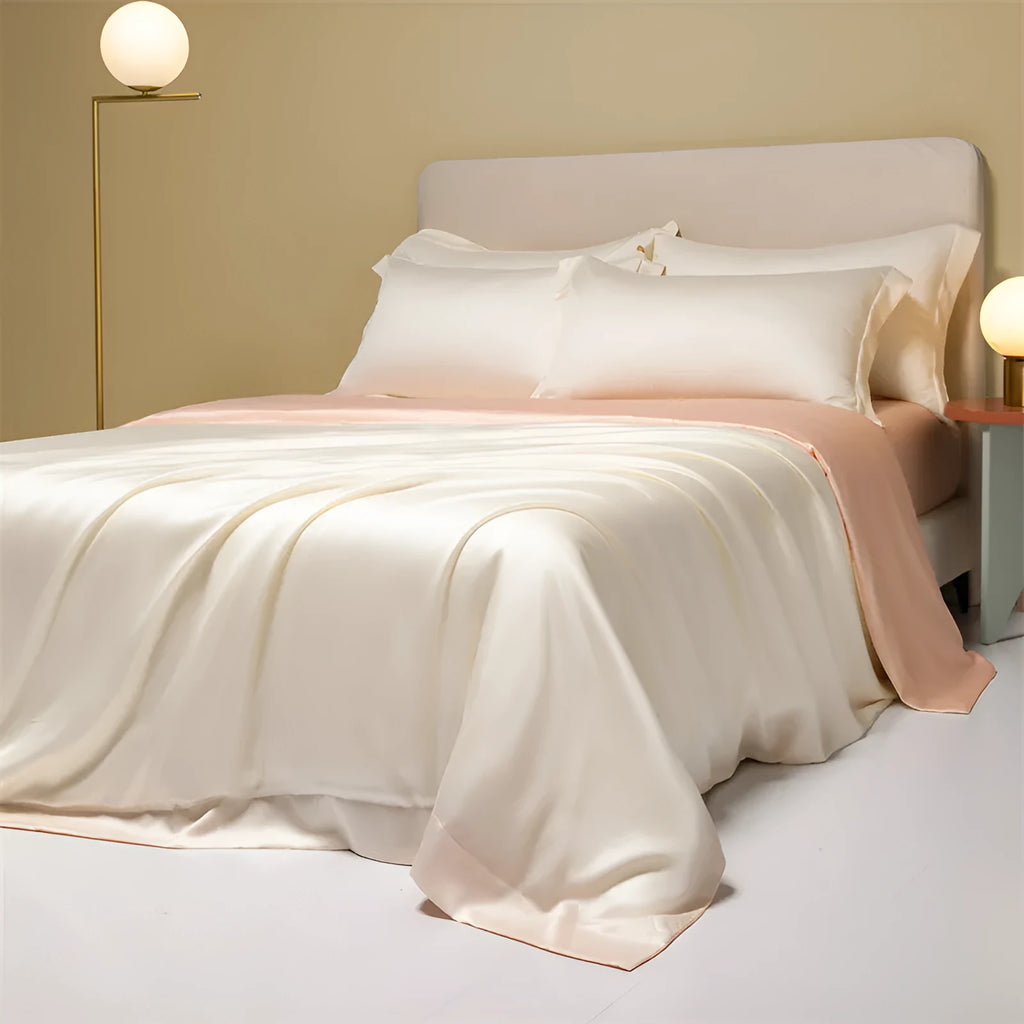 Luxury Lenzing Tencel quilt cover and pillowcases in Aurora Blue on a bed, showing satin weave texture.