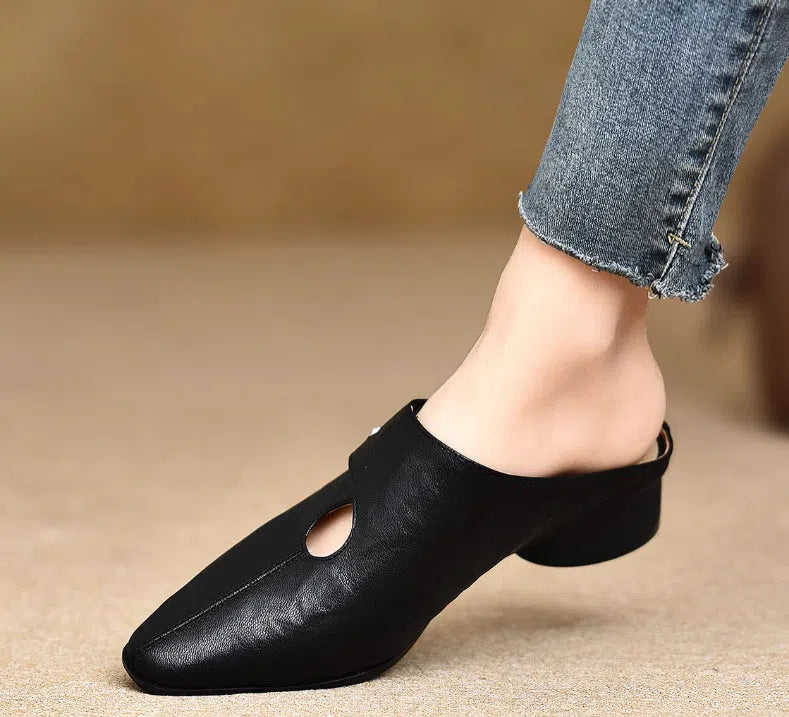 Women's slip-on slippers in first-layer sheepskin with hand-stitched pattern and hollow-out design, beige colour, low heel.