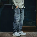 Blue men's loose straight leg retro style trousers with a zip fly on a hanger.