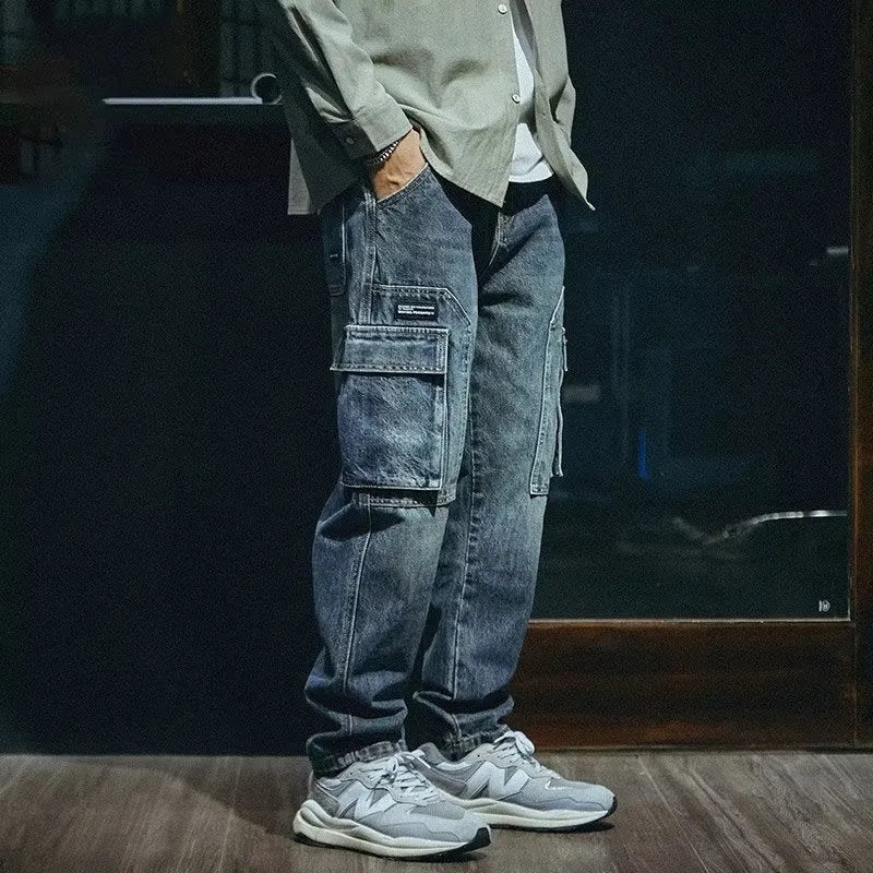 Blue men's loose straight leg retro style trousers with a zip fly on a hanger.