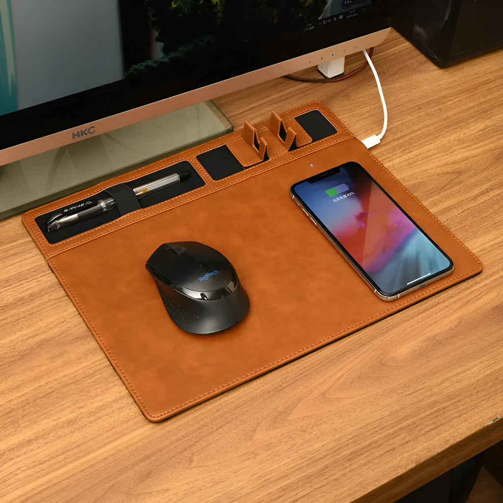 Pink PU leather wireless charging mouse pad with phone holder, 320x260 mm, on a desk.