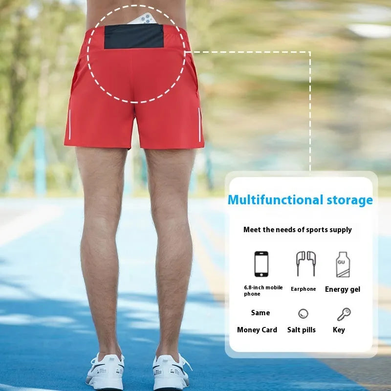 Man wearing high-waisted grey off-road running shorts, showing loose fit and athletic design.