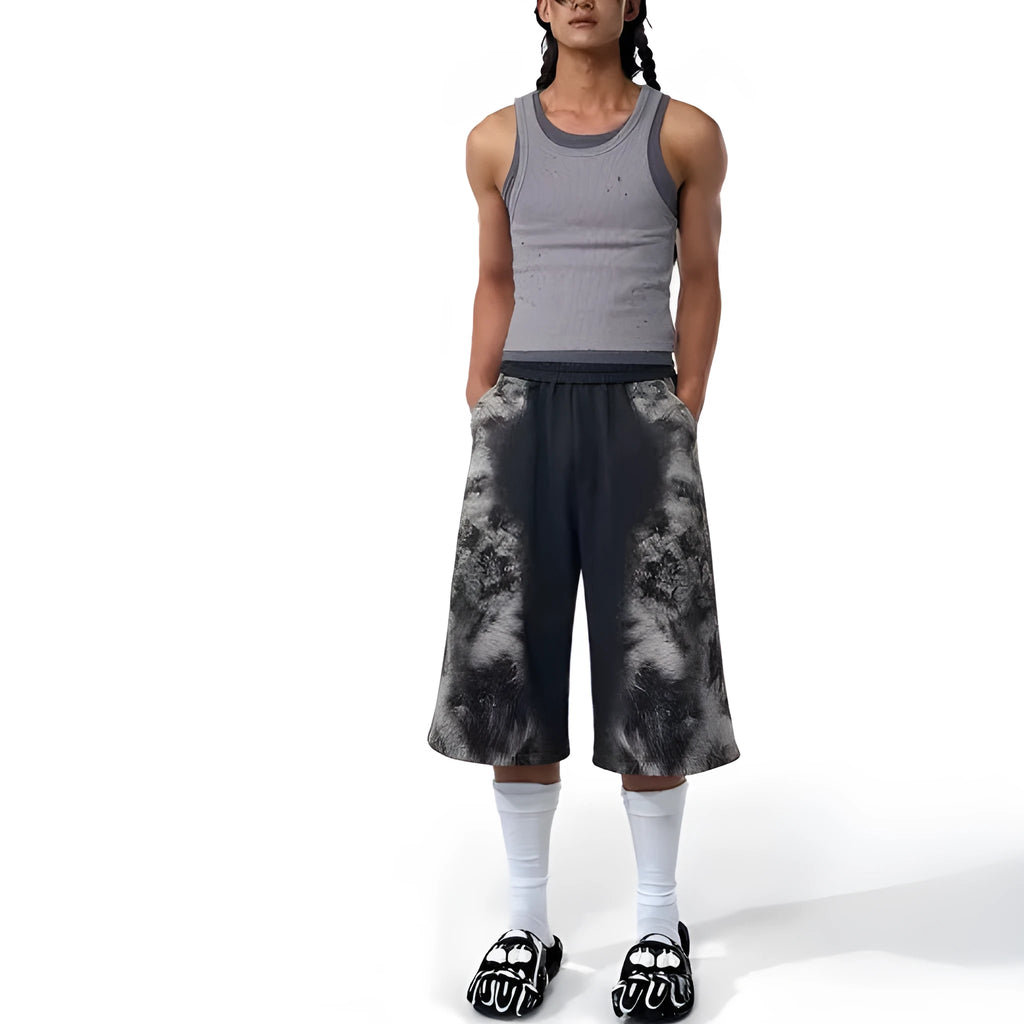 Three-piece streetwear clothing set showing printed hoodie, loose trousers, and shorts with collage stitching detail.