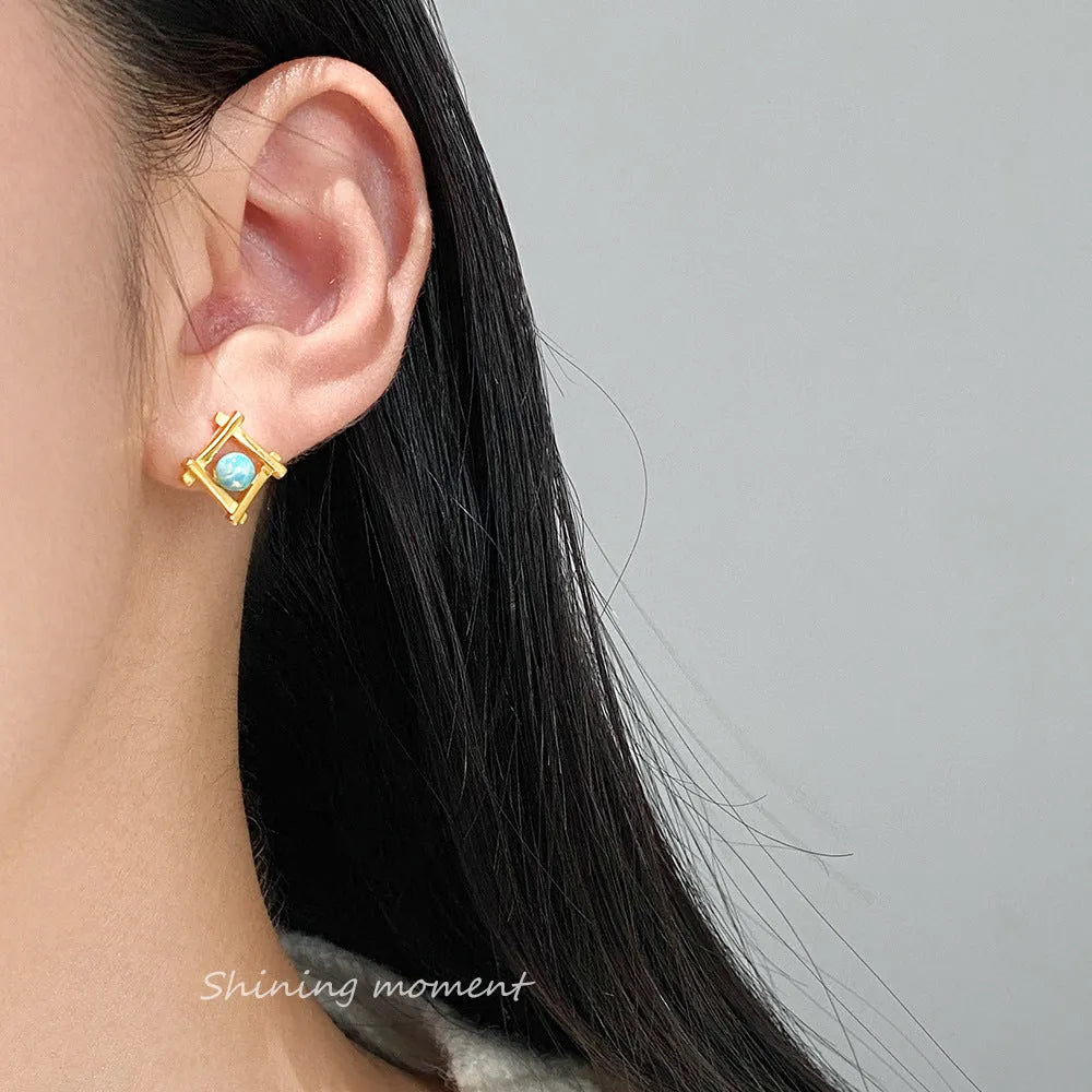 Geometric cross-shaped 925 silver stud earrings in gold and silver tone options.