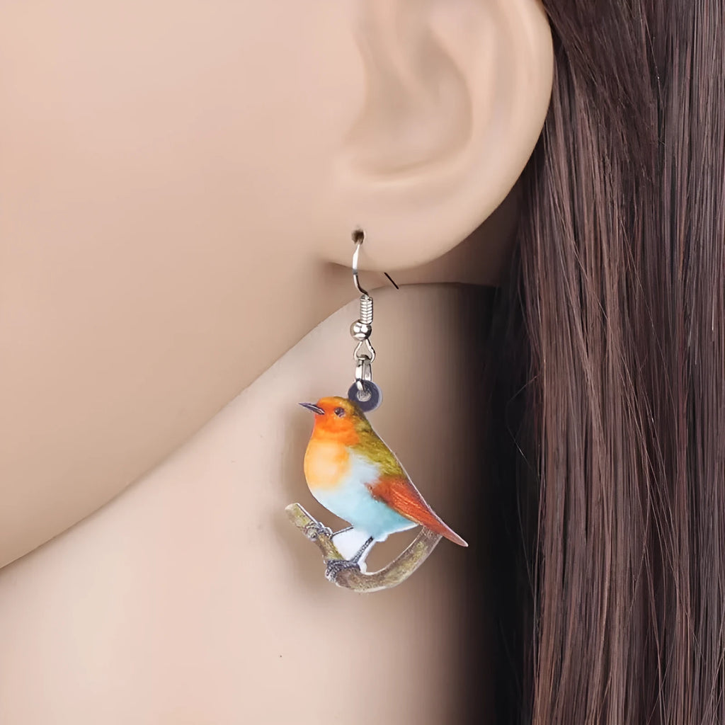 Geometric Blue Tit bird acrylic drop earrings with surgical steel posts on a white background.