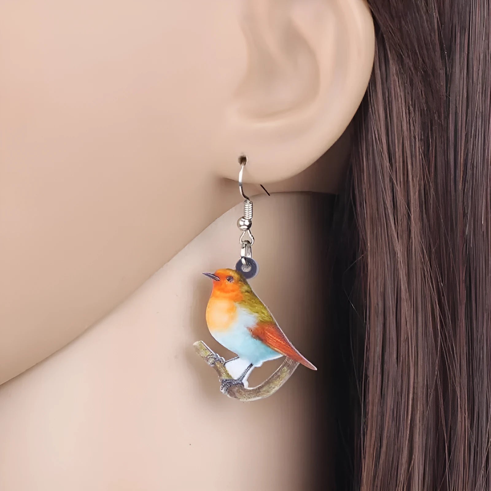 Geometric Blue Tit bird acrylic drop earrings with surgical steel posts on a white background.