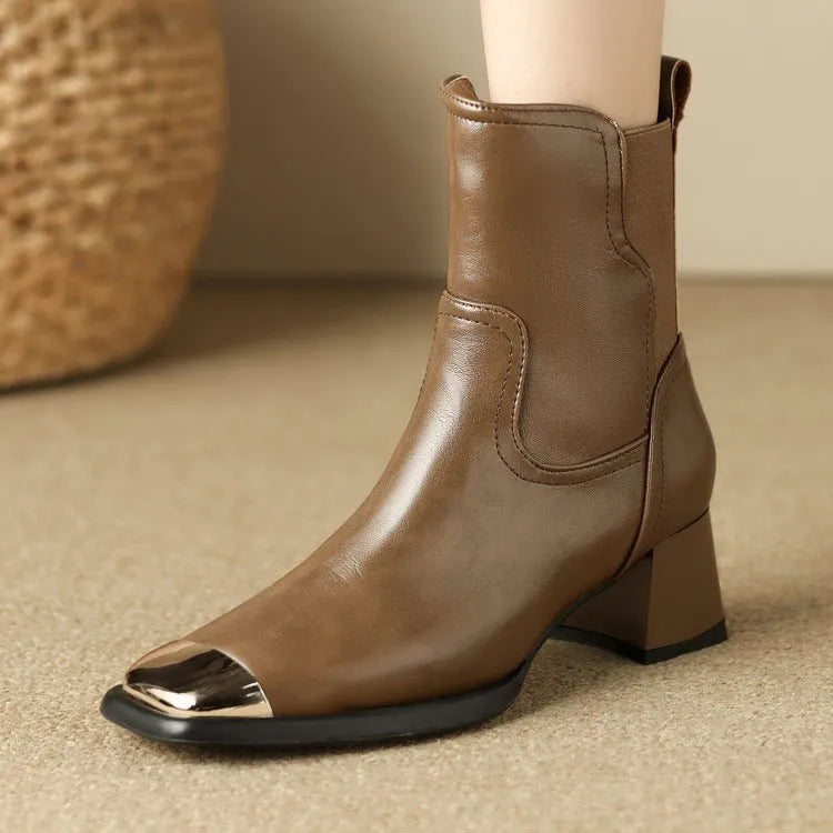 Brown cowhide leather women's Martin boots with high heel and side zipper on a white background.