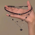 Women's adjustable multi-layer twin necklace with a leather loving heart pendant and crystal accents.