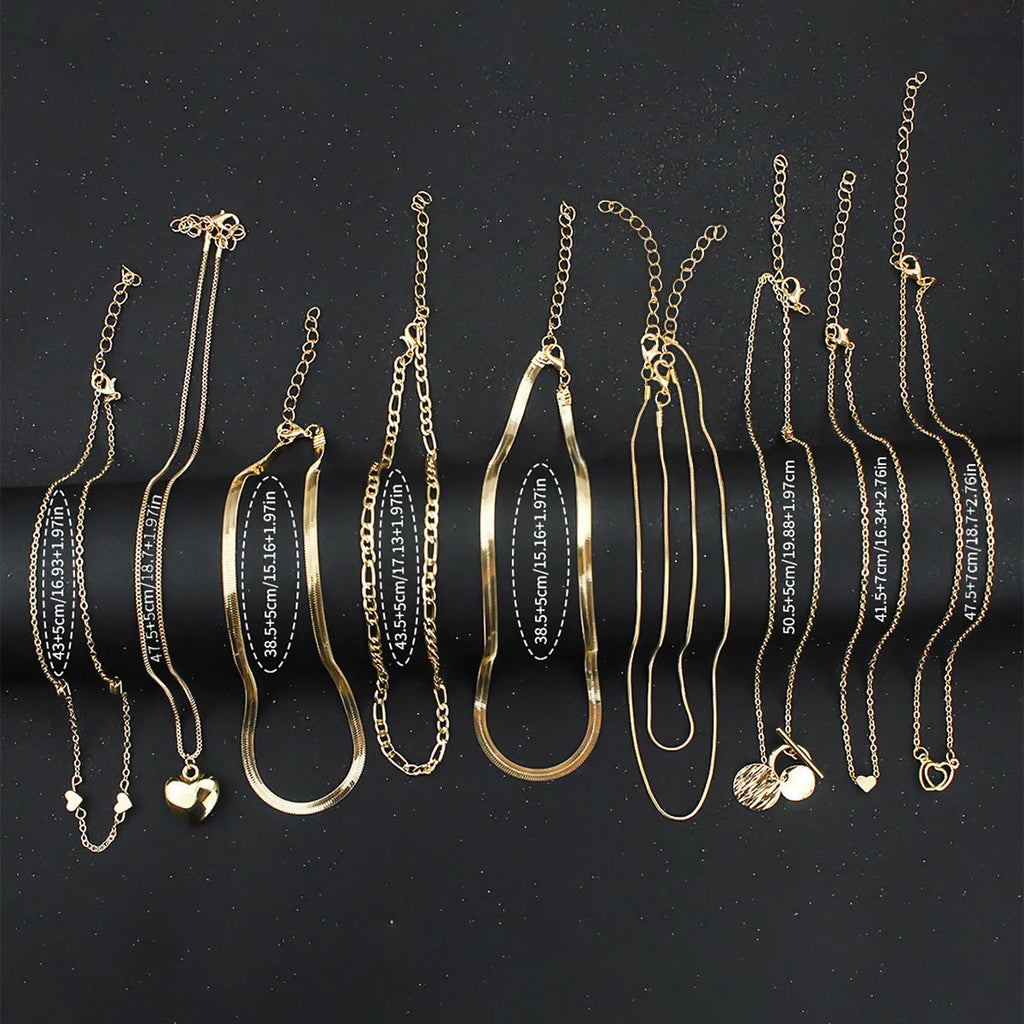 Gold tone women's necklace set with 10 ornamental pieces on snake bone chain