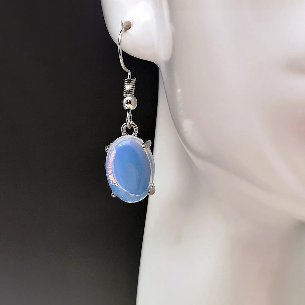 Moonlight white opal earrings with retro drop shape and cross charm detail