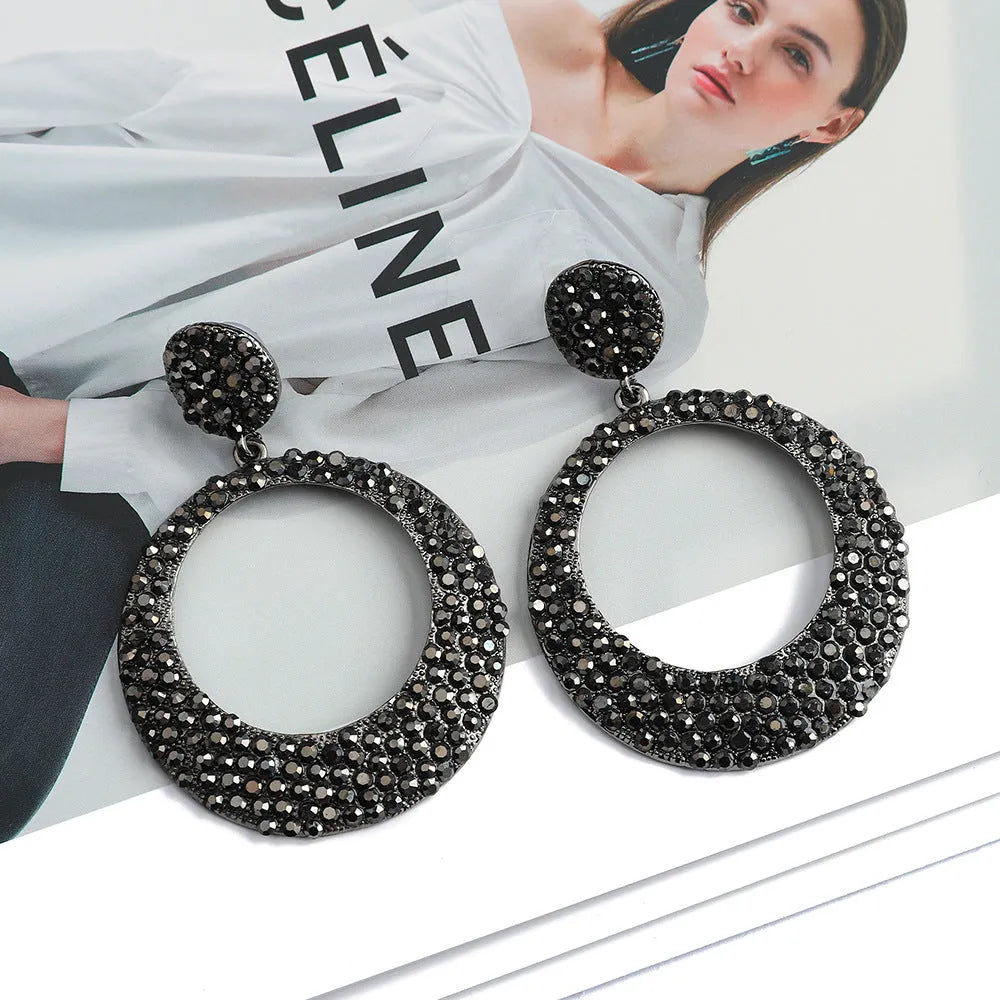 Coloured cartoon-style alloy earrings with a large round pendant and diamond design.