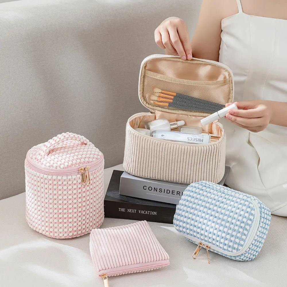 Flannelette makeup bag travel set showing cube-shaped main bag and three smaller zip pouches in a blue with white dots colourway.