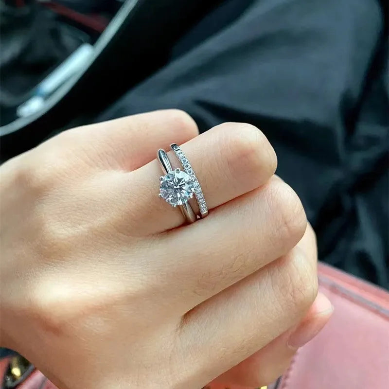Silver Chinese-style couple's ring with dragon, phoenix, and heart design on an adjustable band.