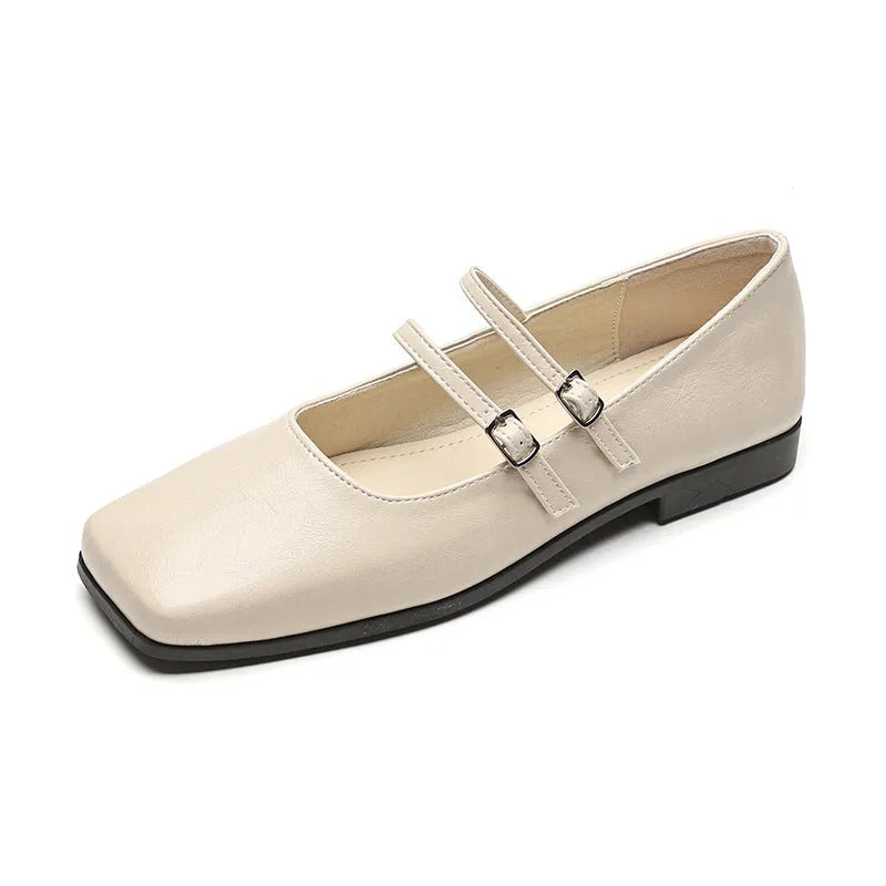 Women's silver leather Mary Jane flats with a cross-buckle strap and flat heel.