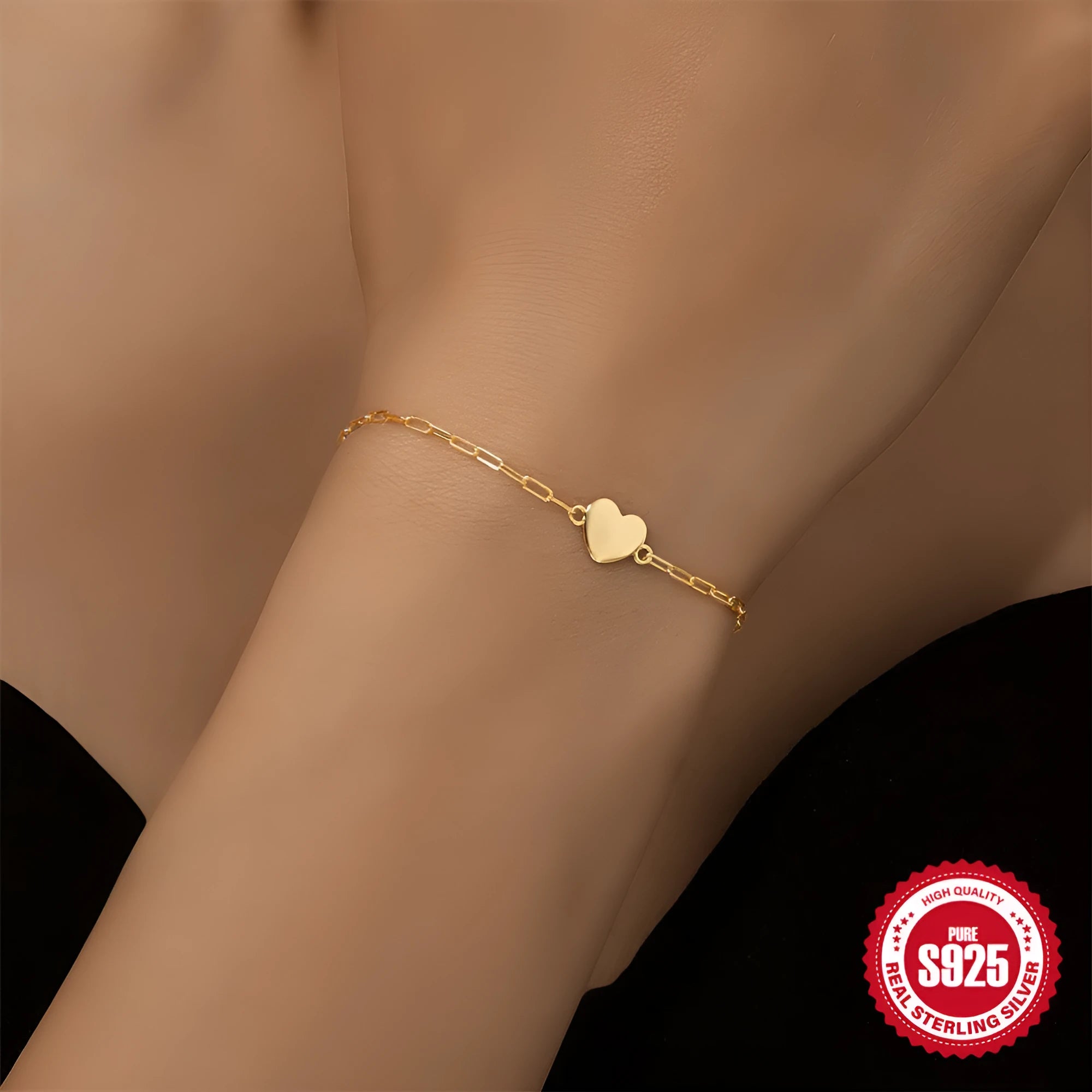 S925 sterling silver bracelet with heart charm and clip chain clasp in gold tone